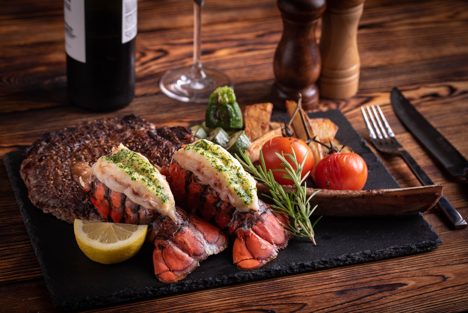 surf and turf with tomahawk rib eye steak and lobster tail